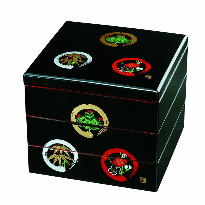 Three-tiered bento box, black with red interior, pine, bamboo and plum blossoms in a circle